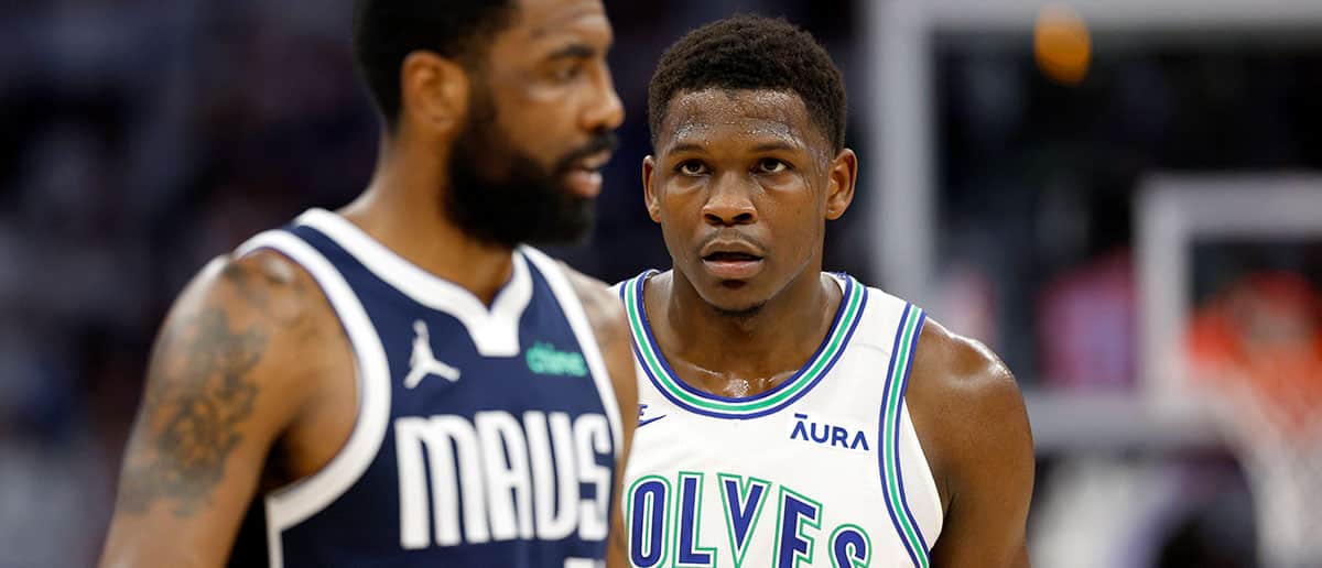 Anthony Edwards #5 of the Minnesota Timberwolves looks at Kyrie Irving #11 of the Dallas Mavericks during the first quarter in Game One of the Western Conference Finals at Target Center on May 22, 2024 in Minneapolis, Minnesota.