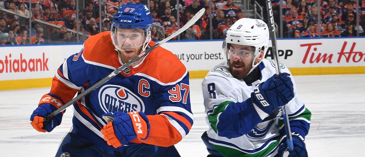 Connor McDavid #97 of the Edmonton Oilers skates against Conor Garland #8 of the Vancouver Canucks in Game Six of the Second Round of the 2024 Stanley Cup Playoffs at Rogers Place on May 18, 2024, in Edmonton, Alberta, Canada.