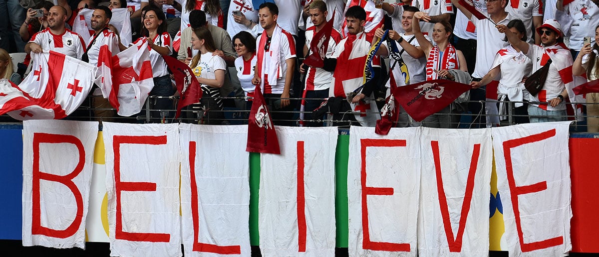 Georgia's supporters wave ahead of the UEFA Euro 2024 Group F football match between Georgia and the Czech Republic at the Volksparkstadion in Hamburg on June 22, 2024