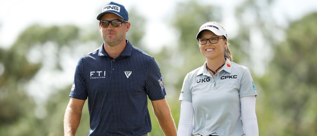 Corey Conners of Canada and Brooke M. Henderson of Canada walk from the second tee during the second round of the Grant Thornton Invitational at Tiburon Golf Club on December 09, 2023 in Naples, Florida.