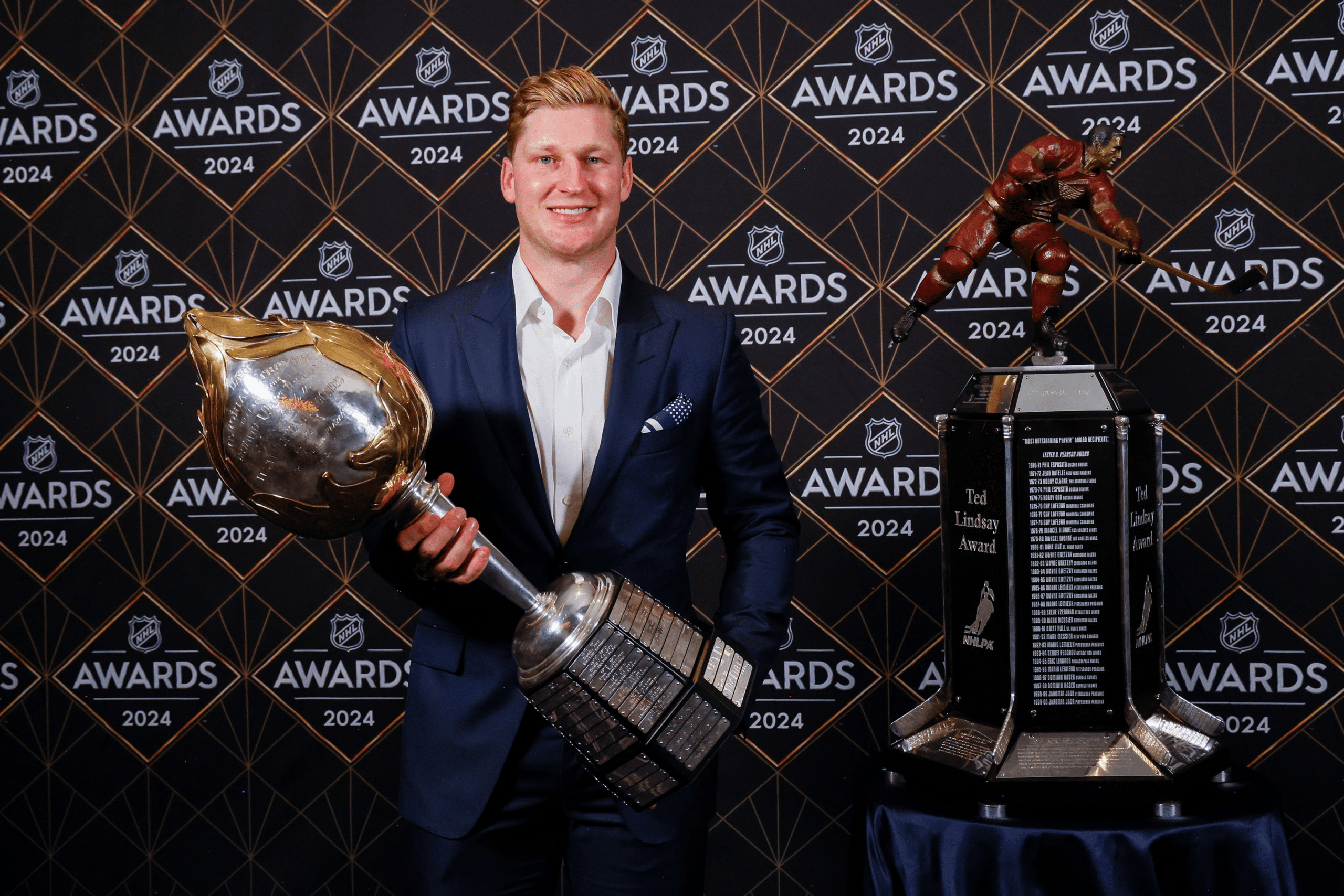 Nathan MacKinnon of the Colorado Avalanche poses with the NHL Hart Trophy in 2024.