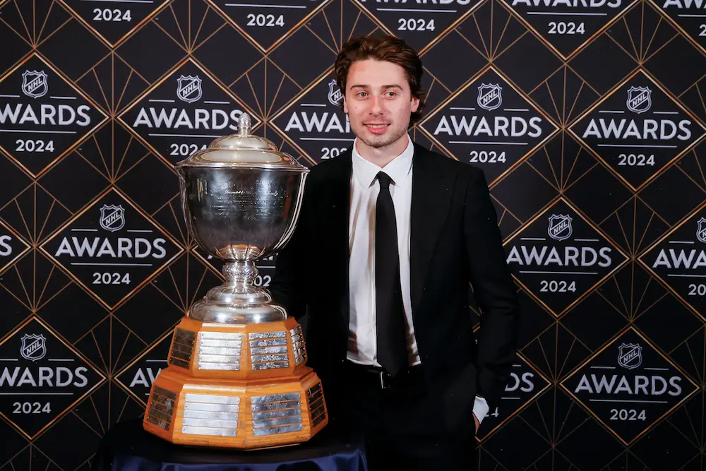 Quinn Hughes of the Vancouver Canucks poses with the James Norris Memorial Trophy during the 2024 NHL Awards at BleauLive Theater at Fontainebleau Las Vegas on June 27, 2024 in Las Vegas, Nevada.