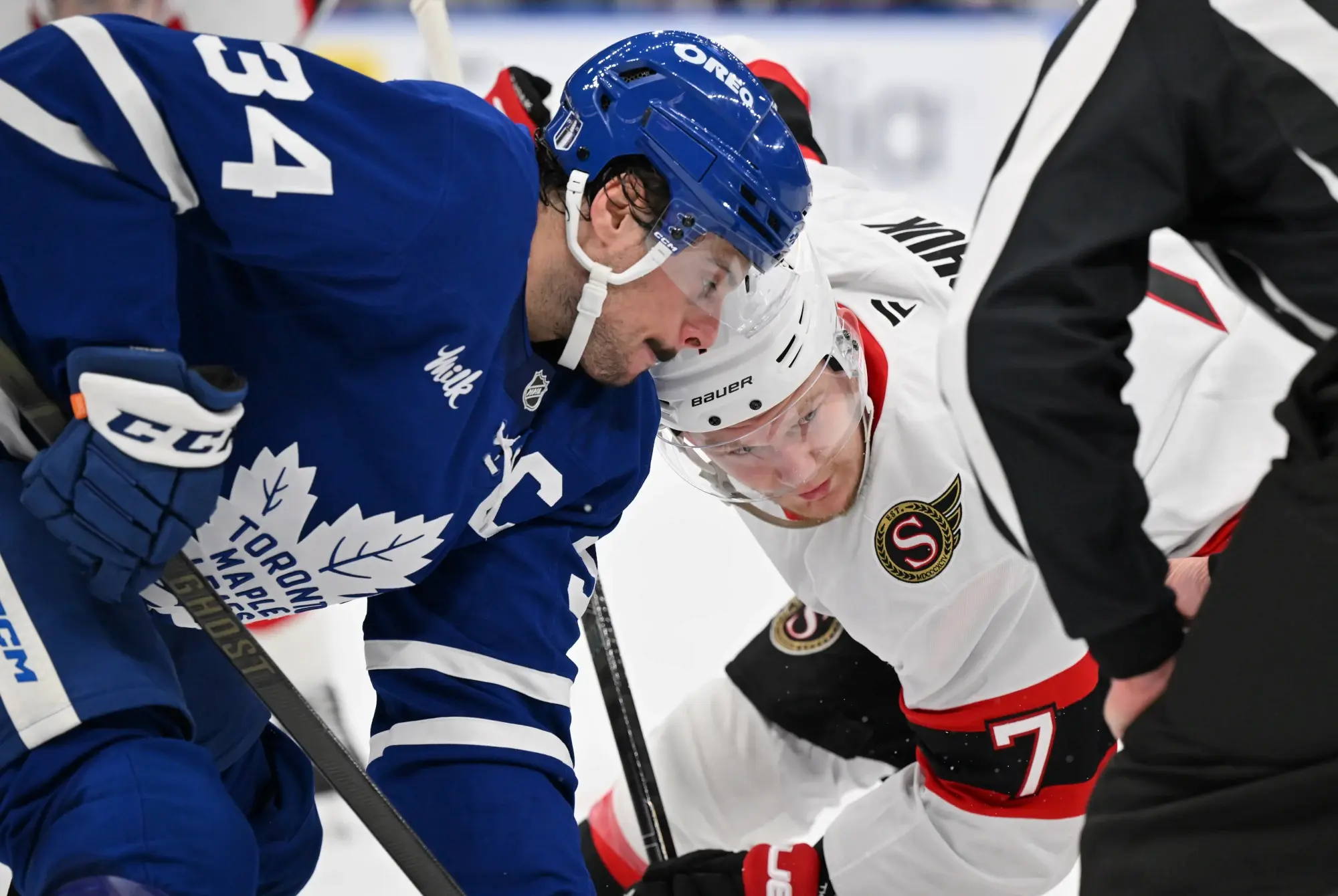 Apr 22, 2025; Toronto, Ontario, CAN; Toronto Maple Leafs forward Auston Matthews (34) and Ottawa Senators forward Brady Tkachuk (7) line up for a face off in the second period in game two of the first round of the 2025 Stanley Cup Playoffs at Scotiabank Arena. 
