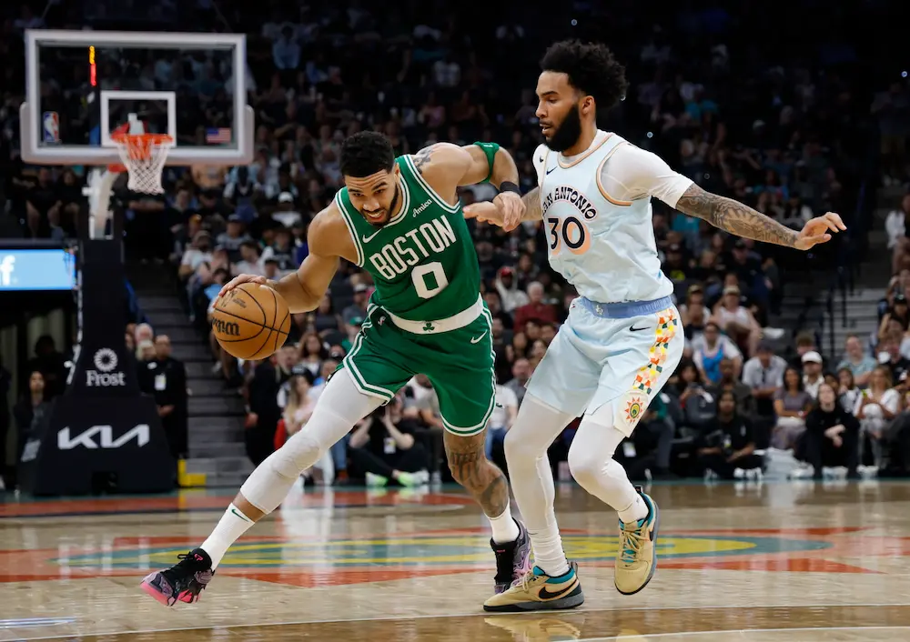 Jayson Tatum #0 of the Boston Celtics drives on Julian Champagnie #30 of the San Antonio Spurs at Frost Bank Center on March 29, 2025 in San Antonio, Texas.