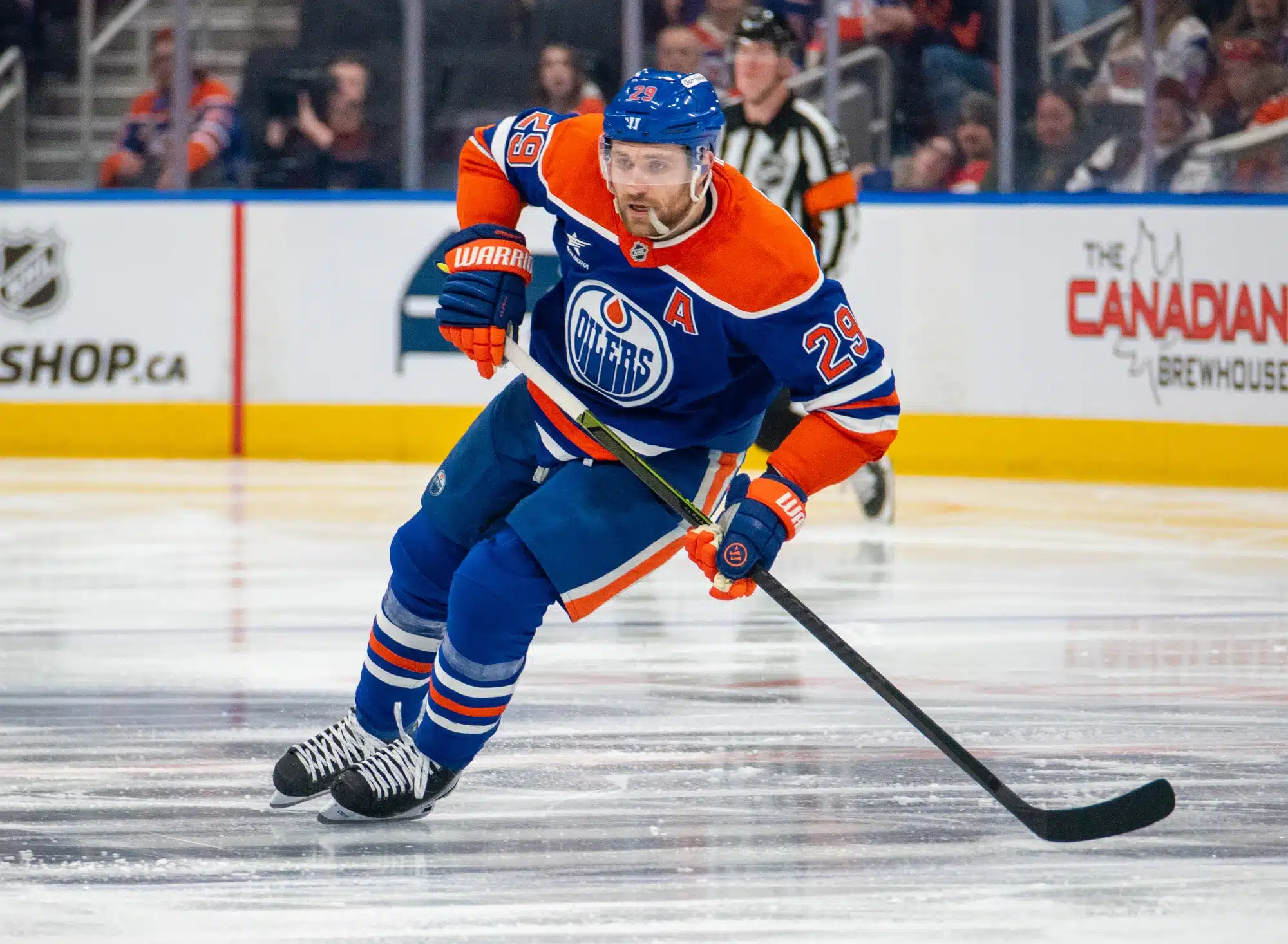 Leon Draisaitl #29 of the Edmonton Oilers  skates with the puck iin mid-ice at an NHL game in April 2025.