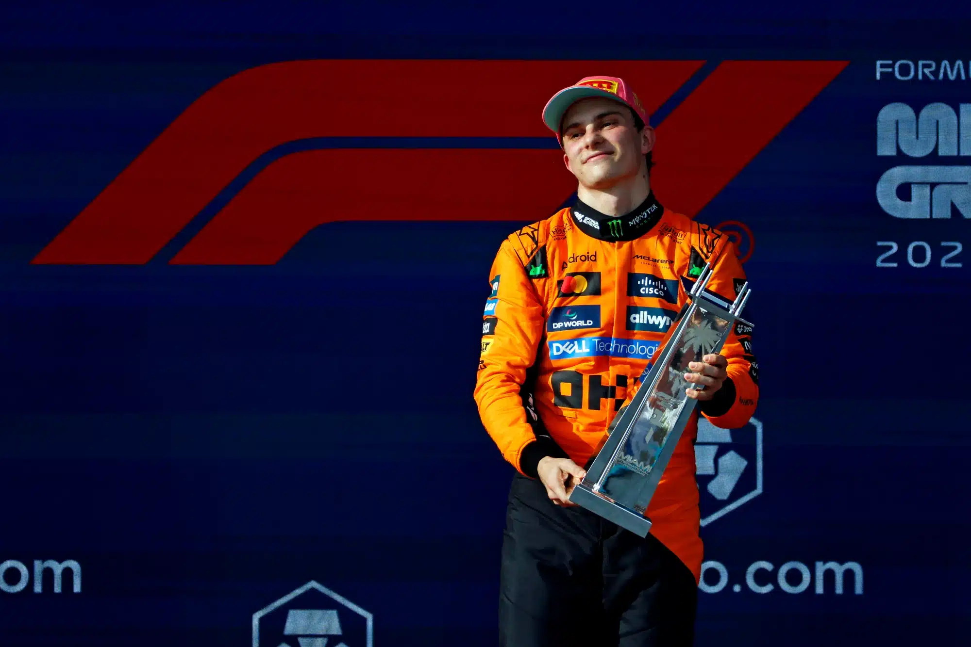 May 4, 2025; Miami Gardens, FL, USA; McLaren driver Oscar Piastri (right) celebrates with the winners trophy after winning the F1 Miami Grand Prix at Miami International Autodrome.