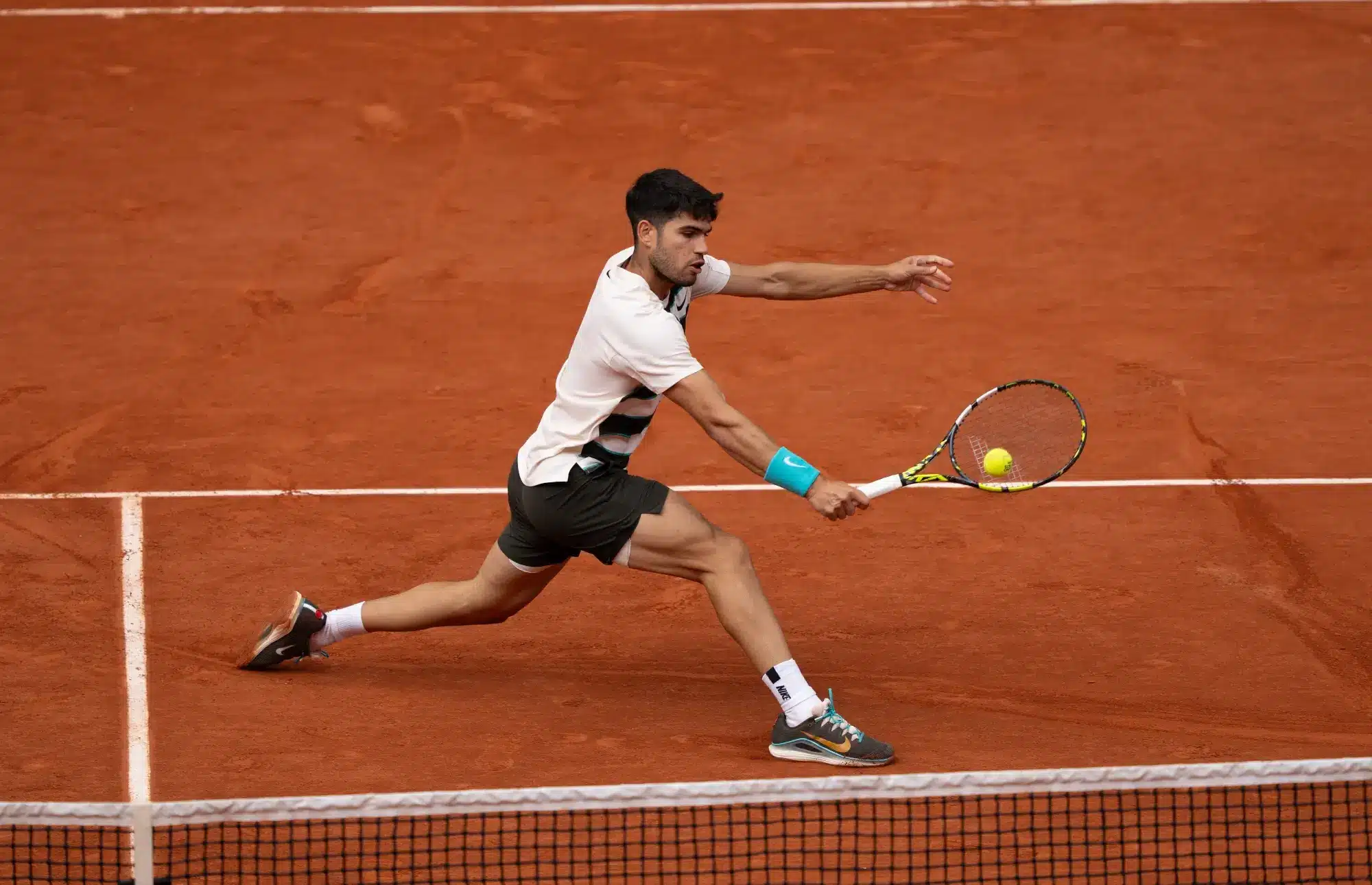 Carlos Alcaraz hit s a tennis ball during the 2025 French Open