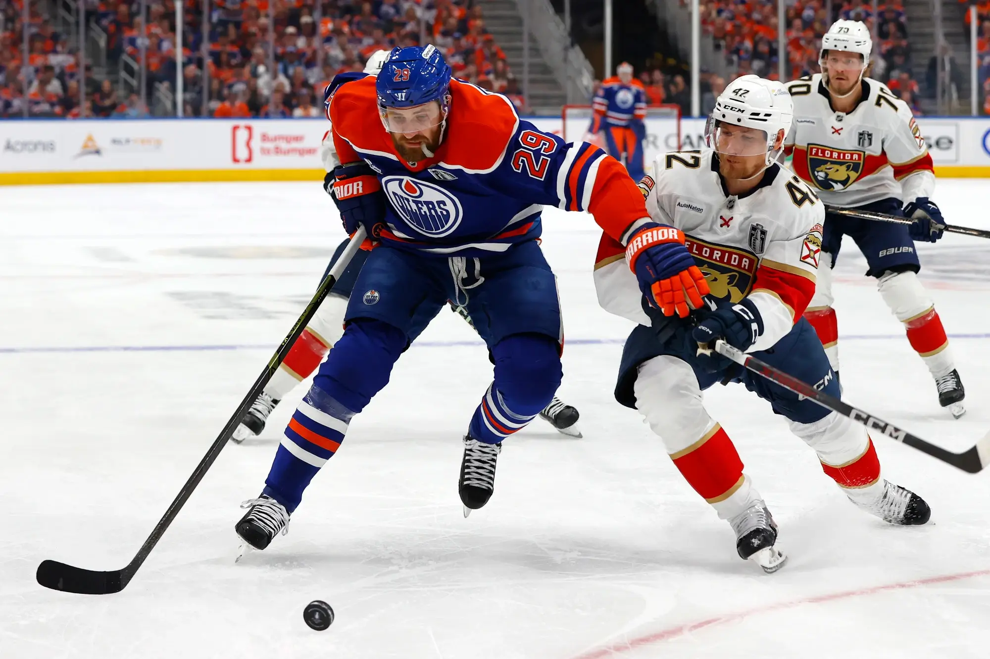 Leon Draisaitl of the Edmonton Oilers battles for the puck against the Florida panthers in Game 1 of the 2025 Stanley Cup finals.