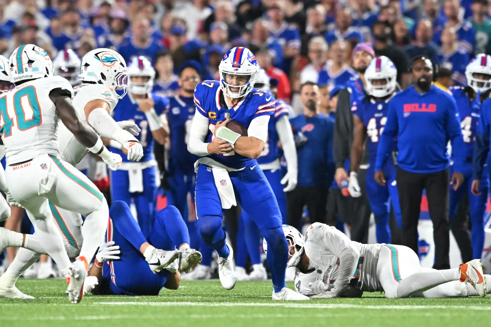 Sep 18, 2025; Orchard Park, New York, USA; Buffalo Bills quarterback Josh Allen (17) runs the ball against the Miami Dolphins in the second half at Highmark Stadium. 