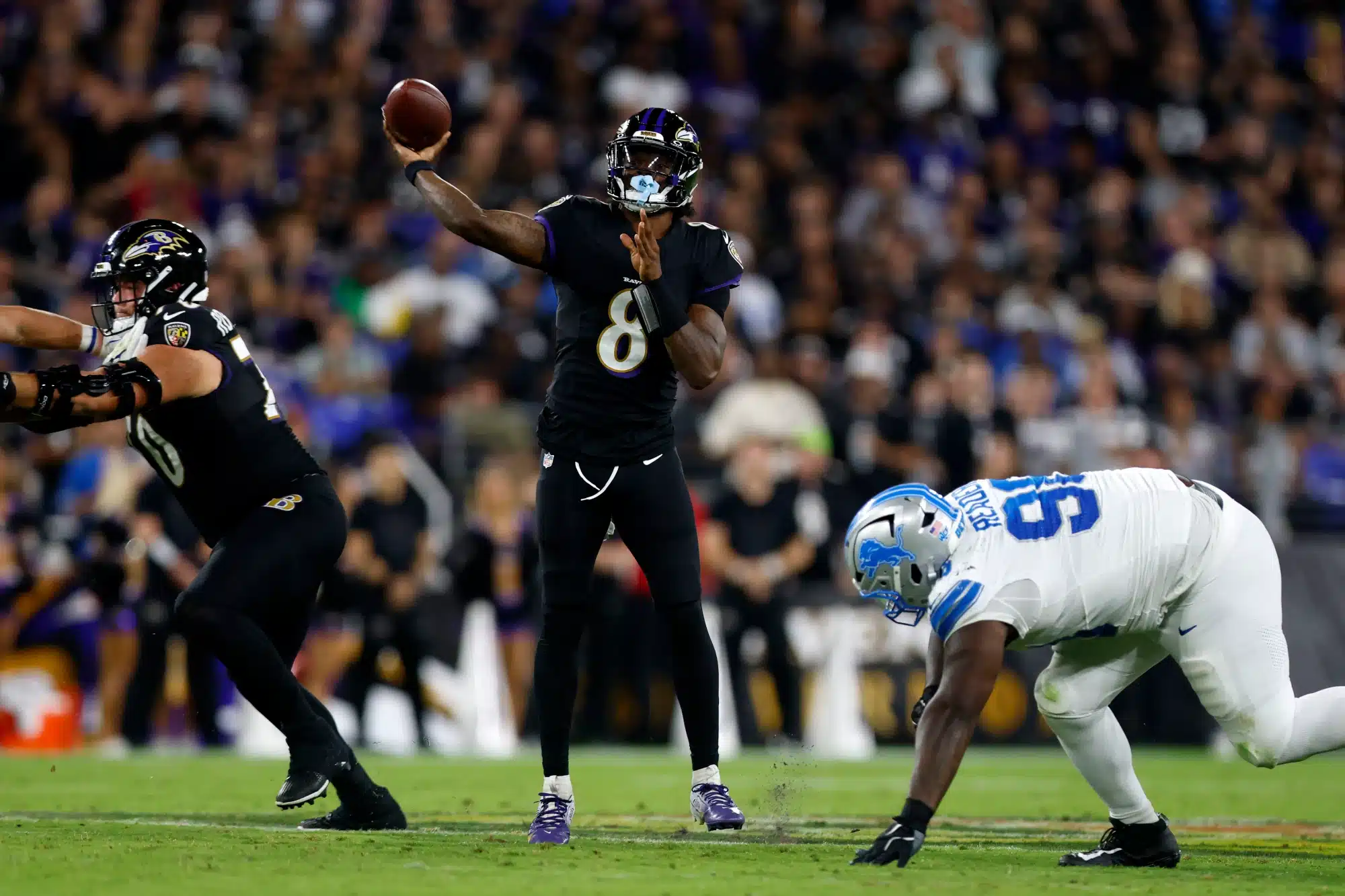 Sep 22, 2025; Baltimore, Maryland, USA; Baltimore Ravens quarterback Lamar Jackson (8) throws pass against the Detroit Lions during the first half at M&T Bank Stadium. 