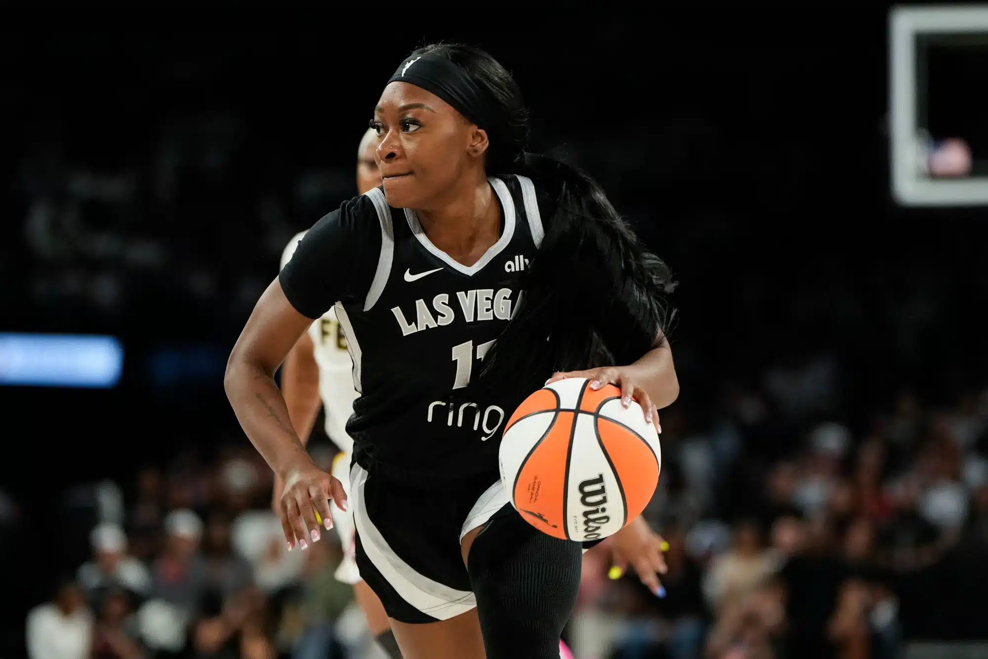 Sep 21, 2025; Las Vegas, Nevada, USA; Las Vegas Aces guard Dana Evans (11) dribbles the ball against the Indiana Fever during the third quarter in game one of the second round for the 2025 WNBA Playoffs at Michelob Ultra Arena.