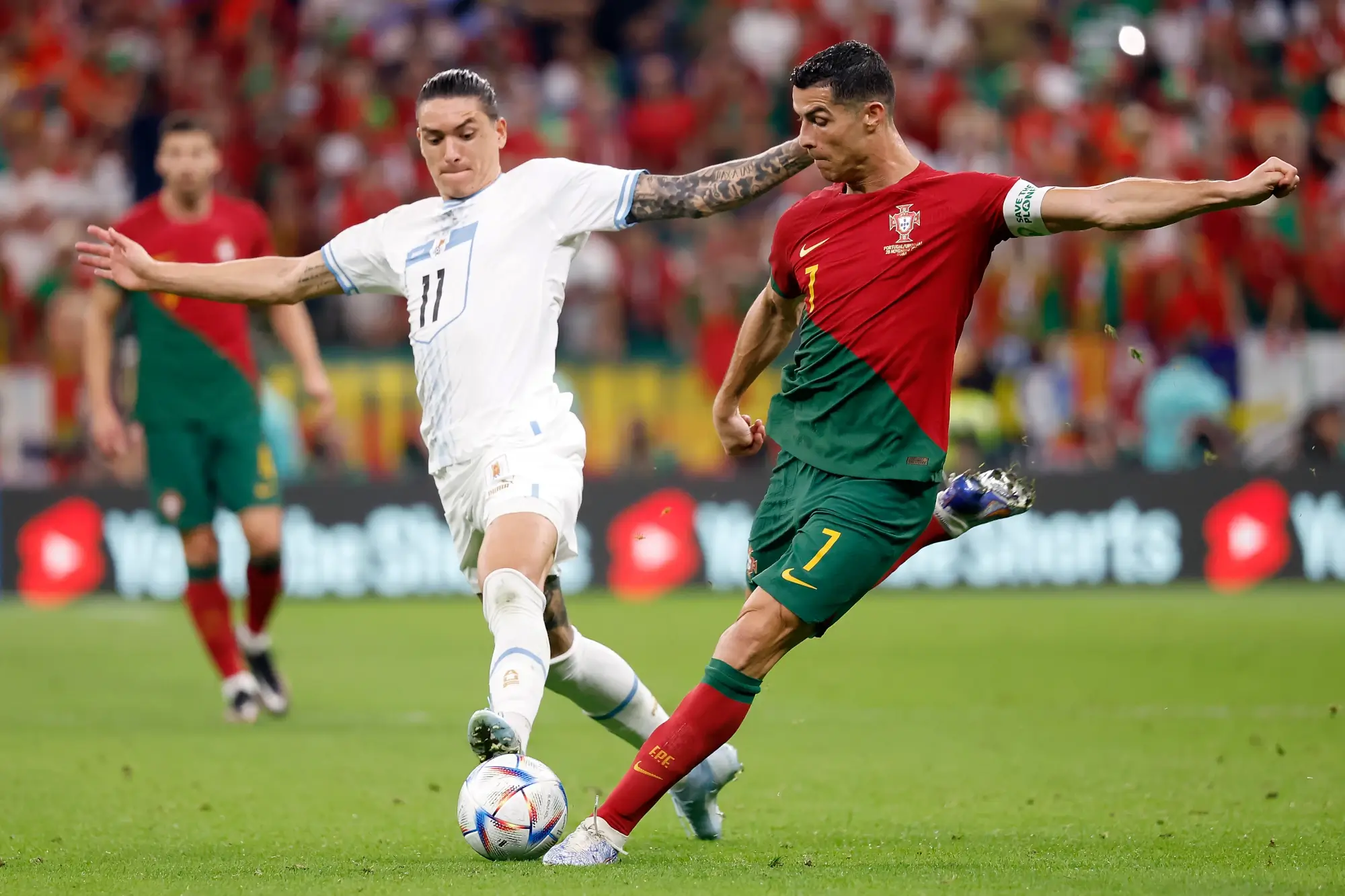 Nov 28, 2022; Lusail, Qatar; Portugal forward Cristiano Ronaldo (7) shoots on goal against Uruguay forward Darwin Nunez (11) during the second half of the group stage match in the 2022 World Cup at Lusail Stadium.