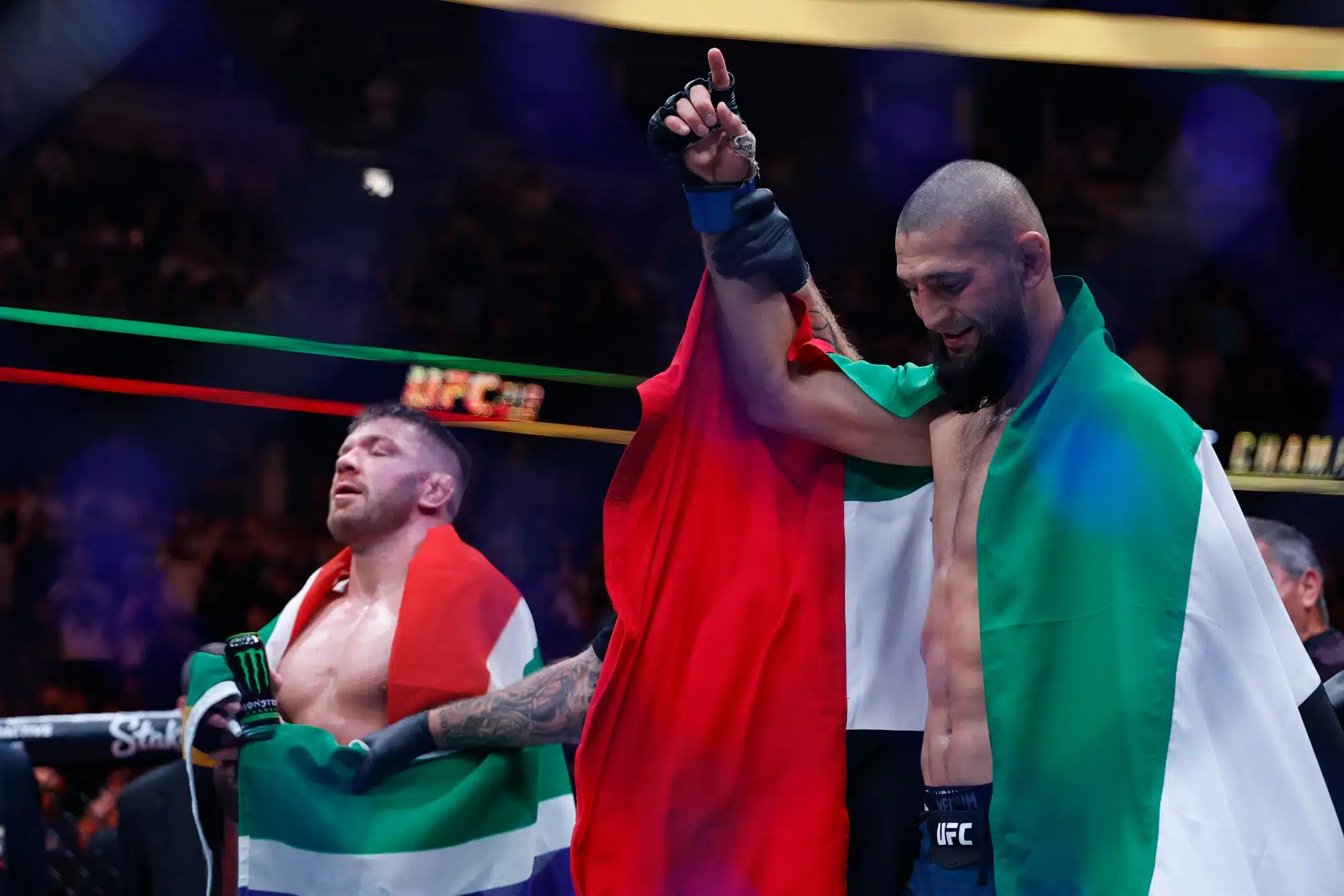 Aug 16, 2025; Chicago, Illinois, UNITED STATES; Khamzat Chimaev (blue gloves) reacts after the fight against Dricus Du Plessis Murphy (red gloves) during UFC 319 at United Center.